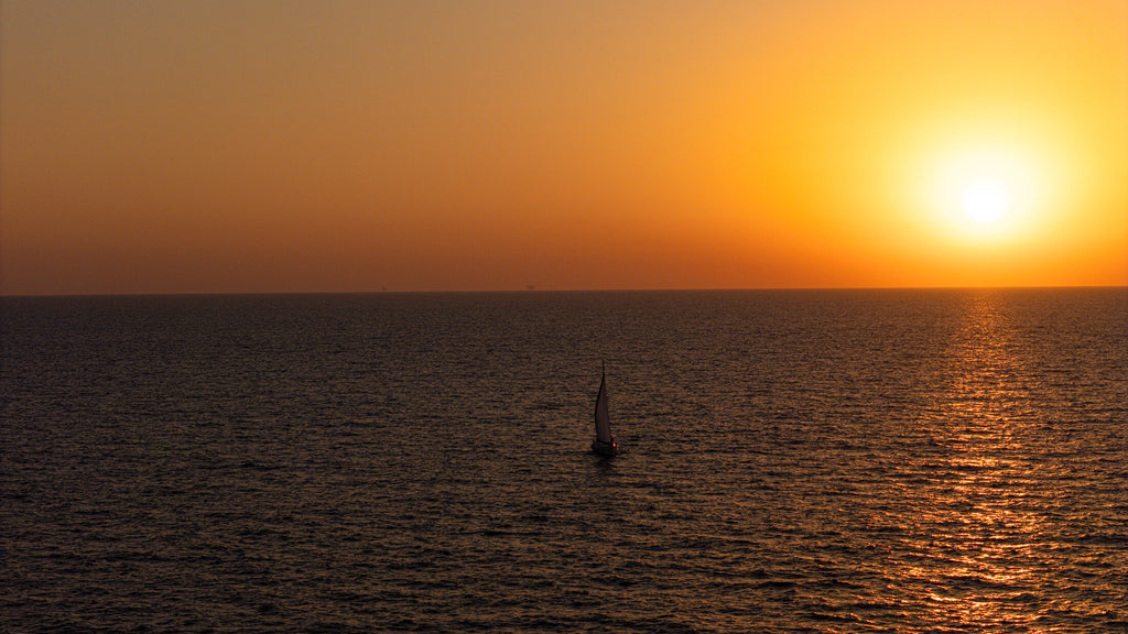 Single sailboat on a golden horizon, fine art print