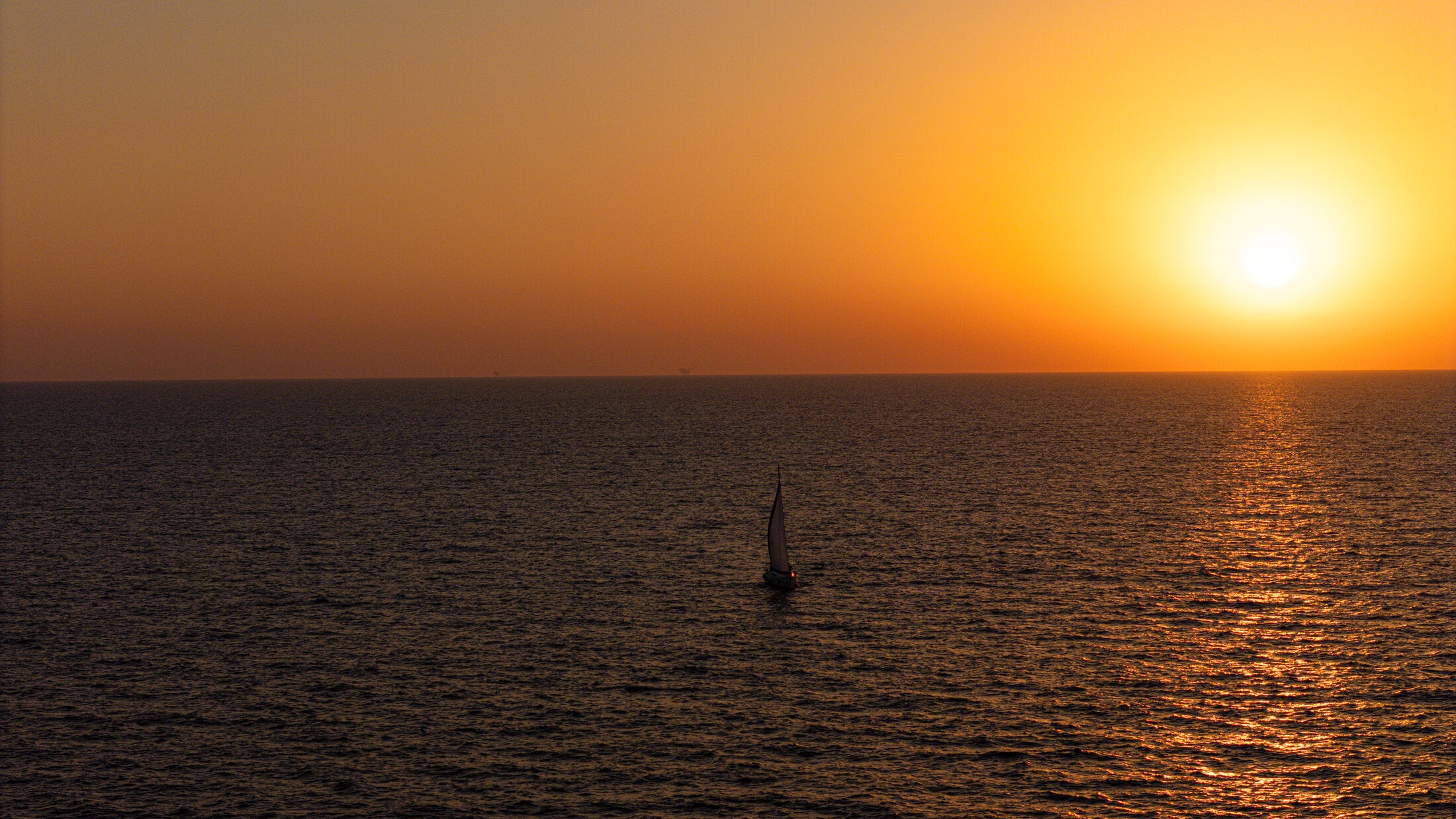 Single sailboat on a golden horizon, fine art print