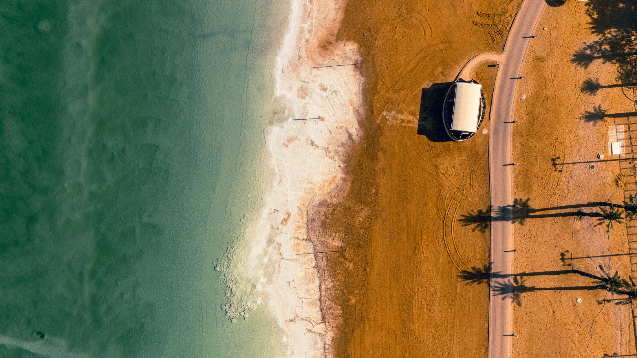 Thatched pavilion on Dead Sea sand, fine art print