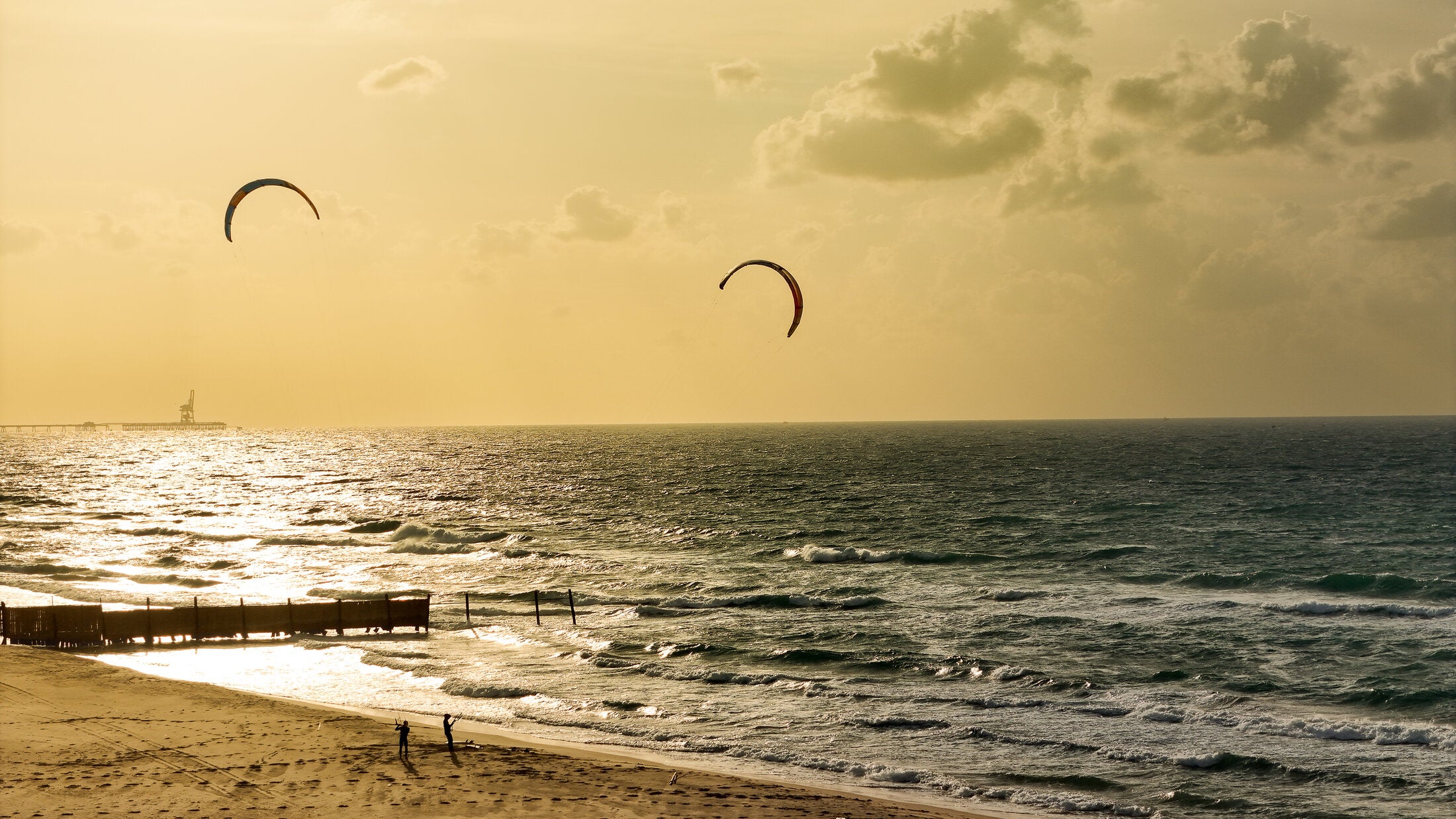 Kite surfers along a hazy coastline, fine art print